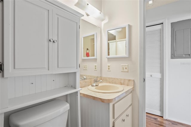 13009 Wedgewood Way Unit 63-D, Hudson, FL 34667 - bathroom with vanity, electric panel, a closet, and wood finished floors
