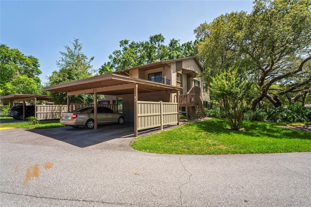 13009 Wedgewood Way Unit 63-D, Hudson, FL 34667 - covered parking lot featuring stairs