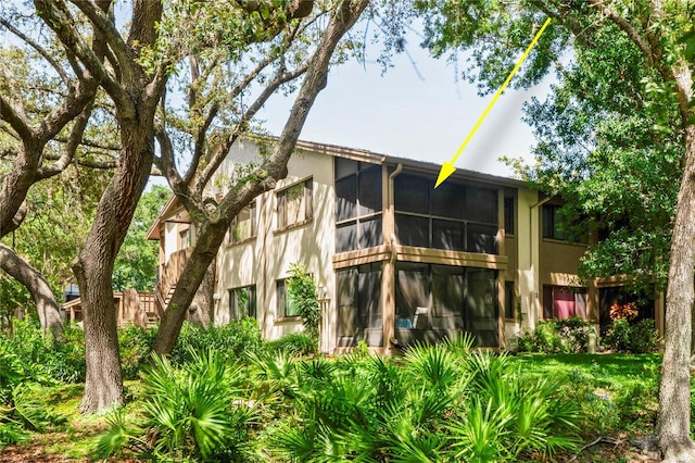 13009 Wedgewood Way Unit 63-D, Hudson, FL 34667 - back of house with a sunroom and stucco siding