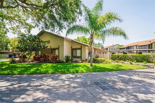 13009 Wedgewood Way Unit 63-D, Hudson, FL 34667 - view of front of property featuring stucco siding and a front yard