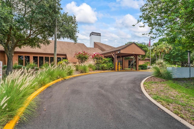 13009 Wedgewood Way Unit 63-D, Hudson, FL 34667 - view of front of home with a chimney and driveway