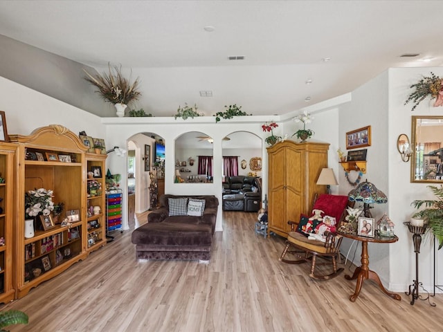 12229 Barnevelde Rd, Weeki Wachee, FL 34614 - living area featuring light wood-style flooring and arched walkways
