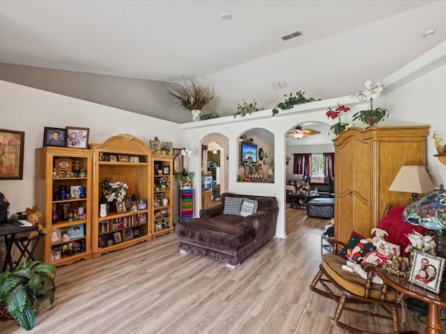 12229 Barnevelde Rd, Weeki Wachee, FL 34614 - living area with light wood finished floors, lofted ceiling, and arched walkways