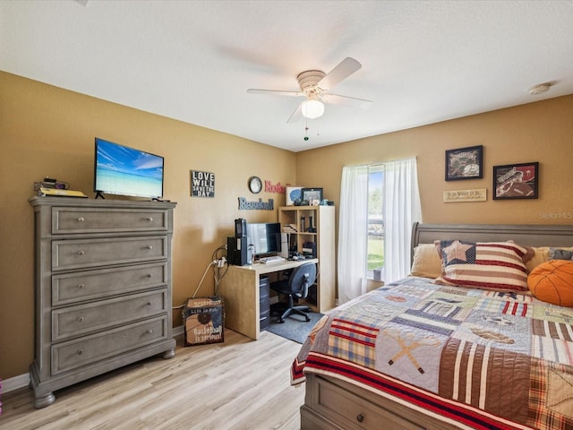 12229 Barnevelde Rd, Weeki Wachee, FL 34614 - bedroom featuring light wood-style flooring, an office area, and a ceiling fan