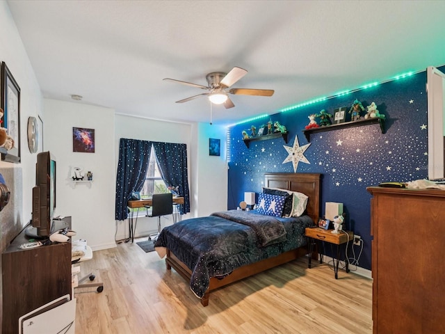 12229 Barnevelde Rd, Weeki Wachee, FL 34614 - bedroom with wood finished floors, baseboards, ceiling fan, and wallpapered walls