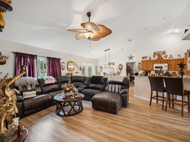 12229 Barnevelde Rd, Weeki Wachee, FL 34614 - living area with vaulted ceiling, ceiling fan, and light wood finished floors