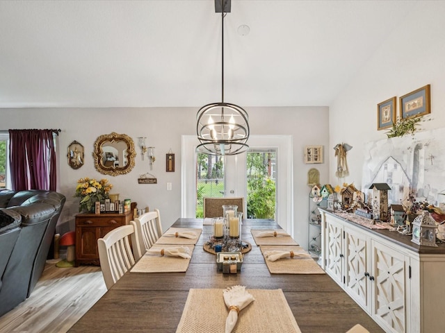12229 Barnevelde Rd, Weeki Wachee, FL 34614 - dining area with healthy amount of natural light, a chandelier, and light wood-style floors