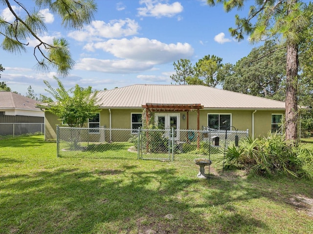 12229 Barnevelde Rd, Weeki Wachee, FL 34614 - back of house with stucco siding, french doors, a gate, and metal roof