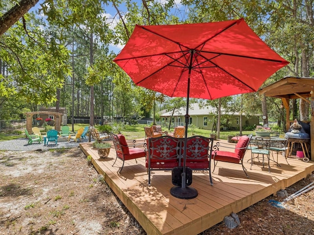 12229 Barnevelde Rd, Weeki Wachee, FL 34614 - wooden terrace featuring a fenced backyard, an outdoor living space, and outdoor dining area