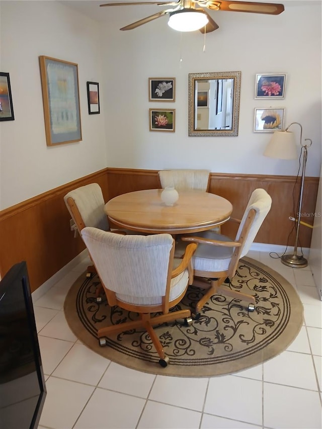 6050 Chesham Dr Unit 3, New Port Richey, FL 34653 - tiled dining area featuring ceiling fan, a wainscoted wall, breakfast area, and wooden walls
