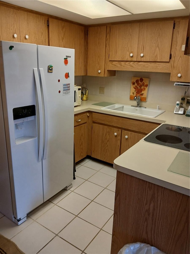 6050 Chesham Dr Unit 3, New Port Richey, FL 34653 - kitchen with white appliances, decorative backsplash, and light countertops