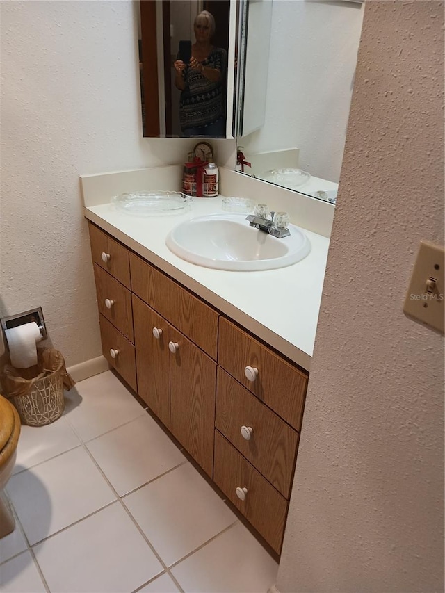 6050 Chesham Dr Unit 3, New Port Richey, FL 34653 - bathroom with vanity, tile patterned floors, and a textured wall