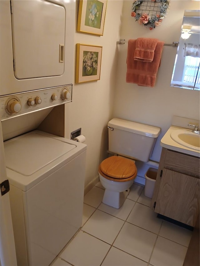 6050 Chesham Dr Unit 3, New Port Richey, FL 34653 - bathroom with stacked washer and clothes dryer, vanity, and tile patterned flooring