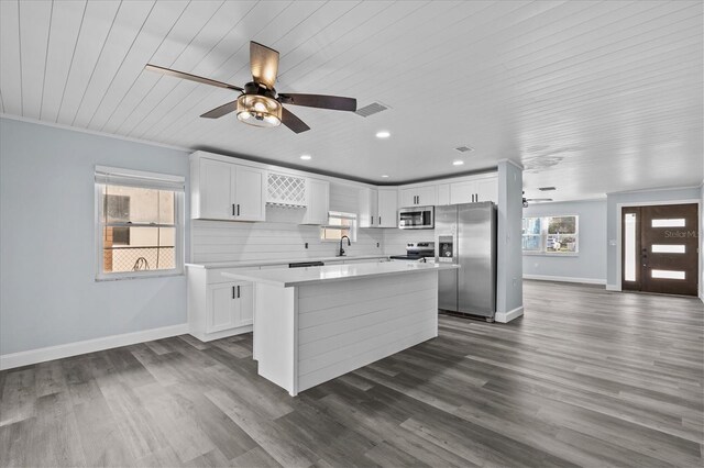 13821 Judy Ave, Hudson, FL 34667 - kitchen with appliances with stainless steel finishes, a ceiling fan, a center island, wooden ceiling, and light countertops