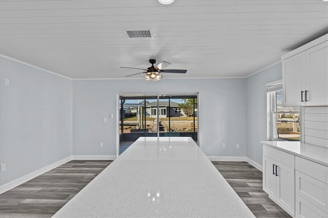 13821 Judy Ave, Hudson, FL 34667 - kitchen featuring crown molding, dark wood-type flooring, white cabinets, ceiling fan, and baseboards