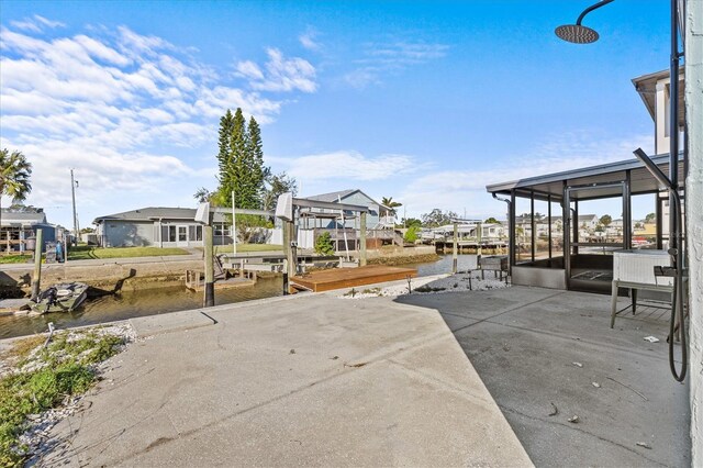13821 Judy Ave, Hudson, FL 34667 - view of patio / terrace with a boat dock, a water view, boat lift, and a sunroom