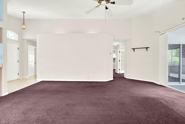 10935 New Brighton Ct, New Port Richey, FL 34654 - unfurnished living room with carpet floors, a high ceiling, and a ceiling fan