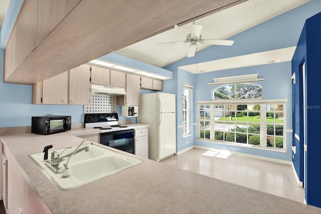 10935 New Brighton Ct, New Port Richey, FL 34654 - kitchen with freestanding refrigerator, range with electric stovetop, under cabinet range hood, vaulted ceiling, and light countertops