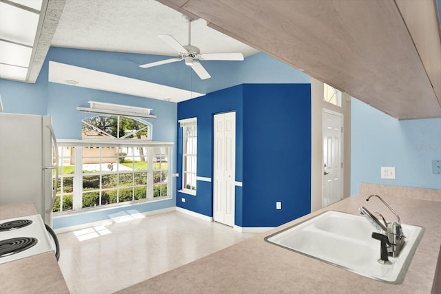 10935 New Brighton Ct, New Port Richey, FL 34654 - kitchen featuring white appliances, a ceiling fan, and high vaulted ceiling