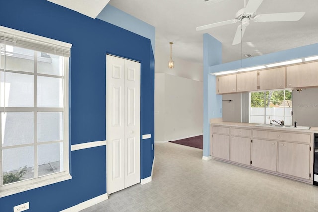 10935 New Brighton Ct, New Port Richey, FL 34654 - kitchen featuring light countertops, ceiling fan, and light brown cabinets