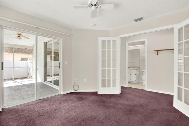 10935 New Brighton Ct, New Port Richey, FL 34654 - unfurnished bedroom featuring carpet flooring, access to exterior, french doors, a ceiling fan, and ensuite bathroom