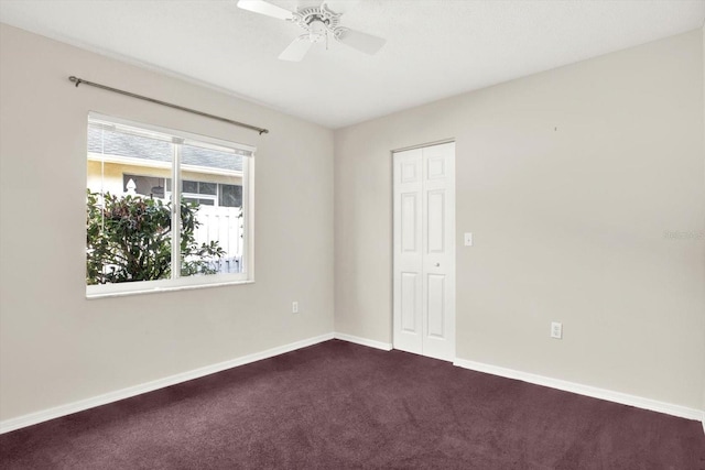 10935 New Brighton Ct, New Port Richey, FL 34654 - spare room with dark colored carpet and ceiling fan
