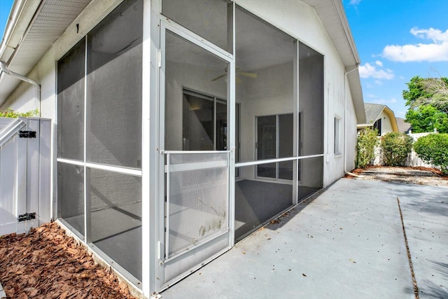 10935 New Brighton Ct, New Port Richey, FL 34654 - view of home's exterior with a sunroom and a patio