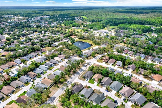 10935 New Brighton Ct, New Port Richey, FL 34654 - aerial overview of property's location featuring a heavily wooded area and nearby suburban area