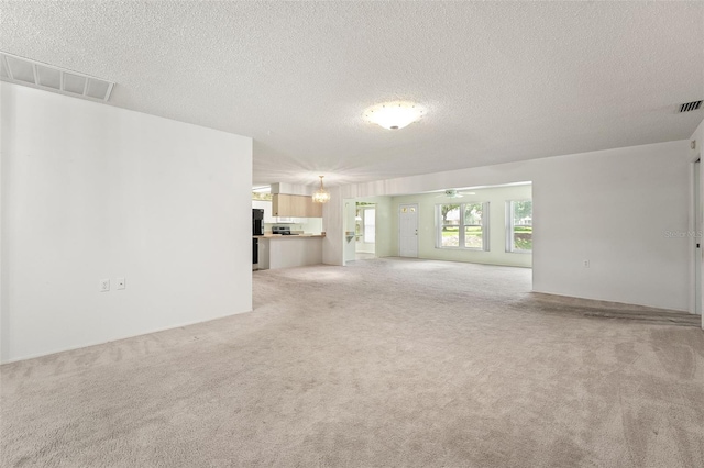 1415 Pinewood Hills Ct, Spring Hill, FL 34606 - unfurnished living room featuring light colored carpet, a textured ceiling, and ceiling fan