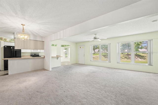 1415 Pinewood Hills Ct, Spring Hill, FL 34606 - unfurnished living room with a textured ceiling, a chandelier, light carpet, and a ceiling fan