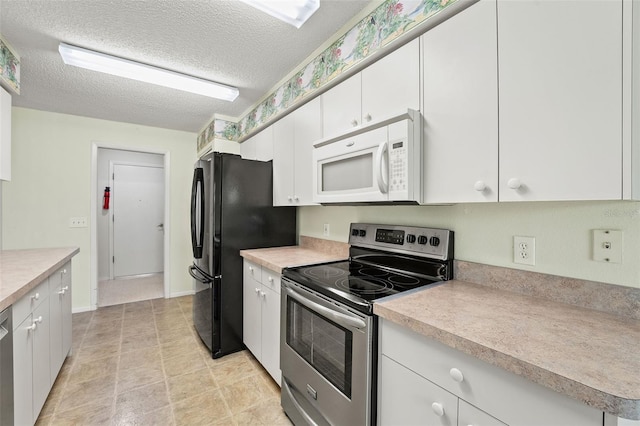 1415 Pinewood Hills Ct, Spring Hill, FL 34606 - kitchen with appliances with stainless steel finishes, white cabinetry, light countertops, and a textured ceiling