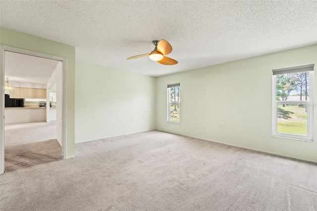 1415 Pinewood Hills Ct, Spring Hill, FL 34606 - carpeted spare room with healthy amount of natural light, ceiling fan, and a textured ceiling