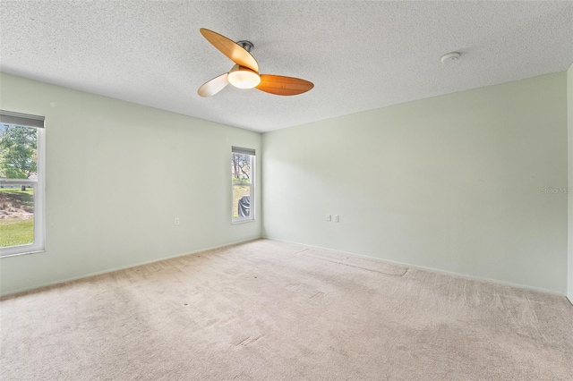 1415 Pinewood Hills Ct, Spring Hill, FL 34606 - spare room with healthy amount of natural light, ceiling fan, carpet, a textured ceiling, and a smoke detector