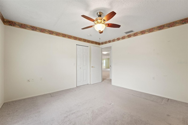 1415 Pinewood Hills Ct, Spring Hill, FL 34606 - unfurnished room with light colored carpet, ceiling fan, and a textured ceiling