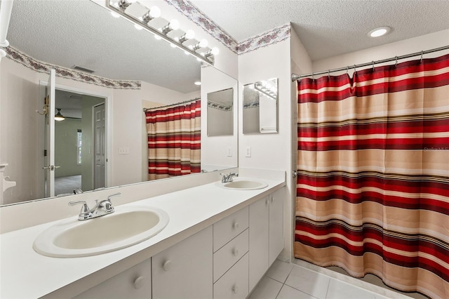 1415 Pinewood Hills Ct, Spring Hill, FL 34606 - full bathroom featuring a textured ceiling, double vanity, tile patterned floors, and a shower with shower curtain