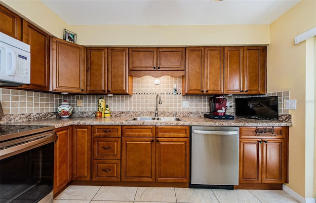 3841 Lanyard Ct Unit B, New Port Richey, FL 34652 - kitchen with stainless steel appliances, brown cabinets, and decorative backsplash