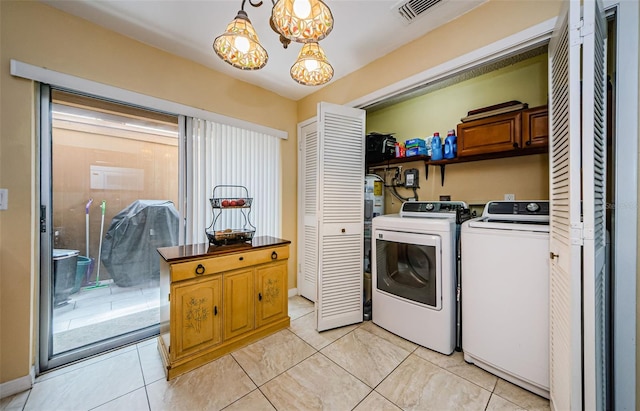 3841 Lanyard Ct Unit B, New Port Richey, FL 34652 - laundry room with independent washer and dryer, cabinet space, and light tile patterned floors