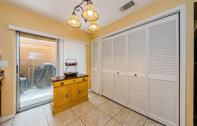 3841 Lanyard Ct Unit B, New Port Richey, FL 34652 - hall with light tile patterned floors and a chandelier