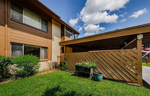 3841 Lanyard Ct Unit B, New Port Richey, FL 34652 - back of house with stucco siding and a lawn
