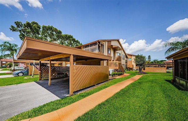 3841 Lanyard Ct Unit B, New Port Richey, FL 34652 - view of side of home with a yard, a carport, and concrete driveway