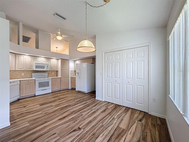 3317 Abigail Ct, New Port Richey, FL 34655 - kitchen with white appliances, dark wood-style flooring, a textured ceiling, light countertops, and a ceiling fan