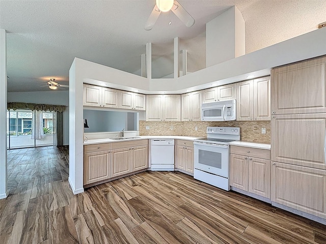 3317 Abigail Ct, New Port Richey, FL 34655 - kitchen with white appliances, ceiling fan, light countertops, backsplash, and high vaulted ceiling