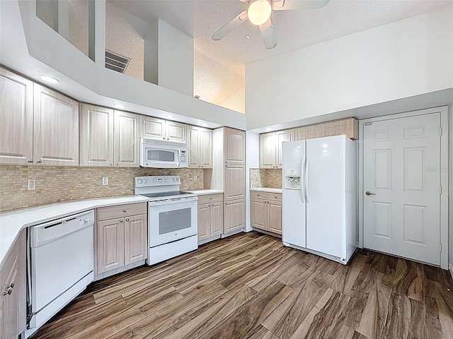 3317 Abigail Ct, New Port Richey, FL 34655 - kitchen featuring white appliances, ceiling fan, light countertops, high vaulted ceiling, and backsplash