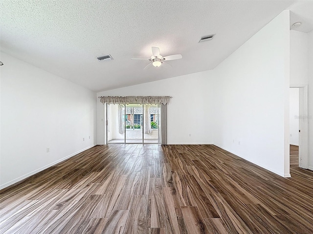 3317 Abigail Ct, New Port Richey, FL 34655 - empty room with vaulted ceiling, ceiling fan, dark wood-style floors, and a textured ceiling