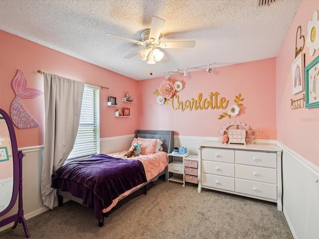 4716 Wolfram Ln, New Port Richey, FL 34653 - bedroom with track lighting, a textured ceiling, light carpet, and ceiling fan