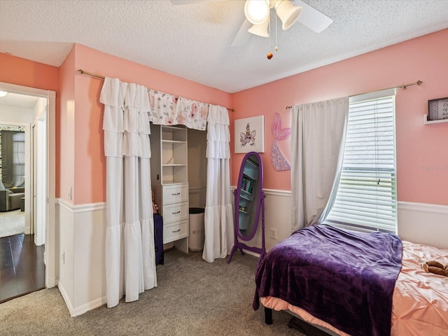 4716 Wolfram Ln, New Port Richey, FL 34653 - carpeted bedroom with a textured ceiling and a ceiling fan