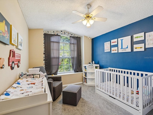 4716 Wolfram Ln, New Port Richey, FL 34653 - bedroom with a nursery area, vaulted ceiling, carpet, a textured ceiling, and a ceiling fan