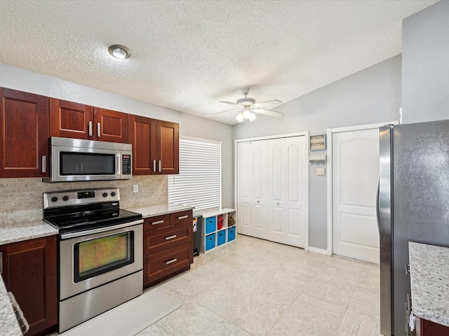 4716 Wolfram Ln, New Port Richey, FL 34653 - kitchen with stainless steel appliances, ceiling fan, decorative backsplash, light stone counters, and a textured ceiling