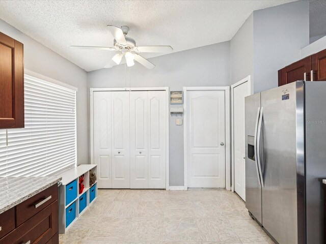 4716 Wolfram Ln, New Port Richey, FL 34653 - kitchen with stainless steel fridge with ice dispenser, ceiling fan, and a textured ceiling