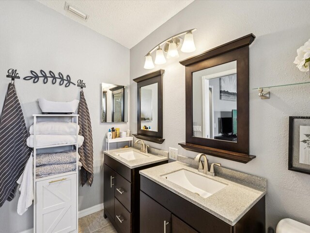 4716 Wolfram Ln, New Port Richey, FL 34653 - bathroom with two vanities and vaulted ceiling